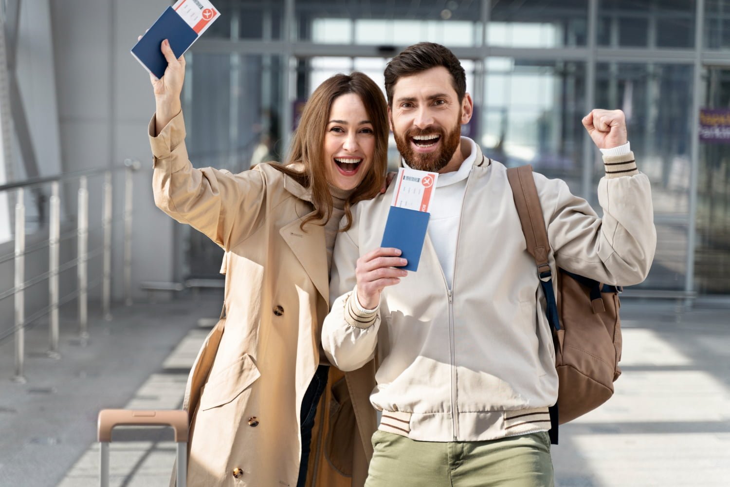 A joyful couple at an airport holding passports and boarding passes, smiling excitedly after getting partner visa. They are dressed in casual travel attire, ready for a journey.